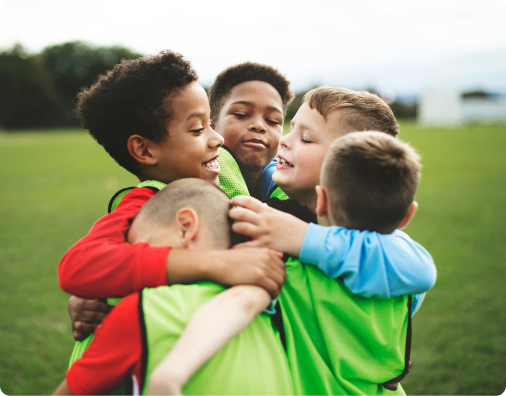 Football team stacking hands together before kick-off, symbolising growth, ambition and stronger club partnerships through the Grow package.